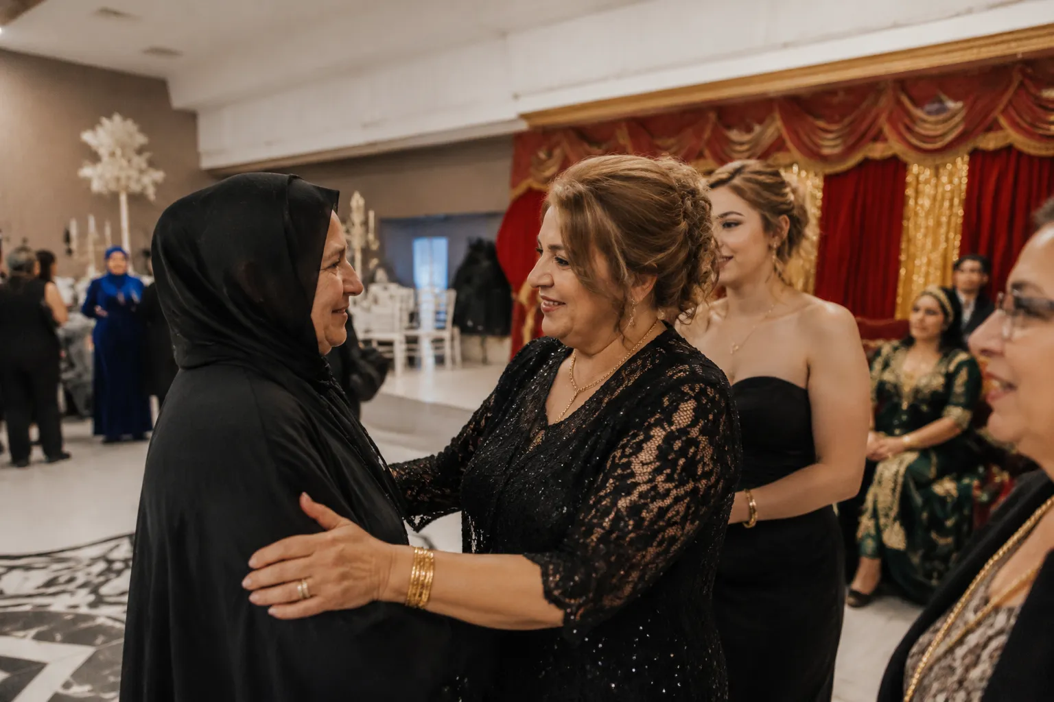 Mother of the bride greeting relatives at a Turkish henna night venue