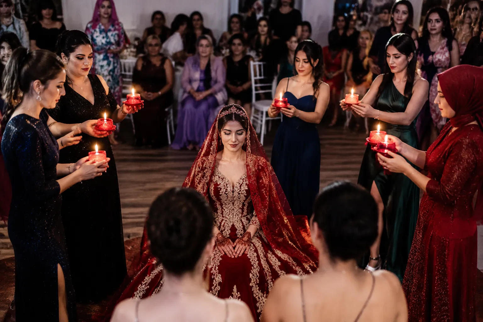 Bride seated during a candlelit kına gecesi henna ceremony moment